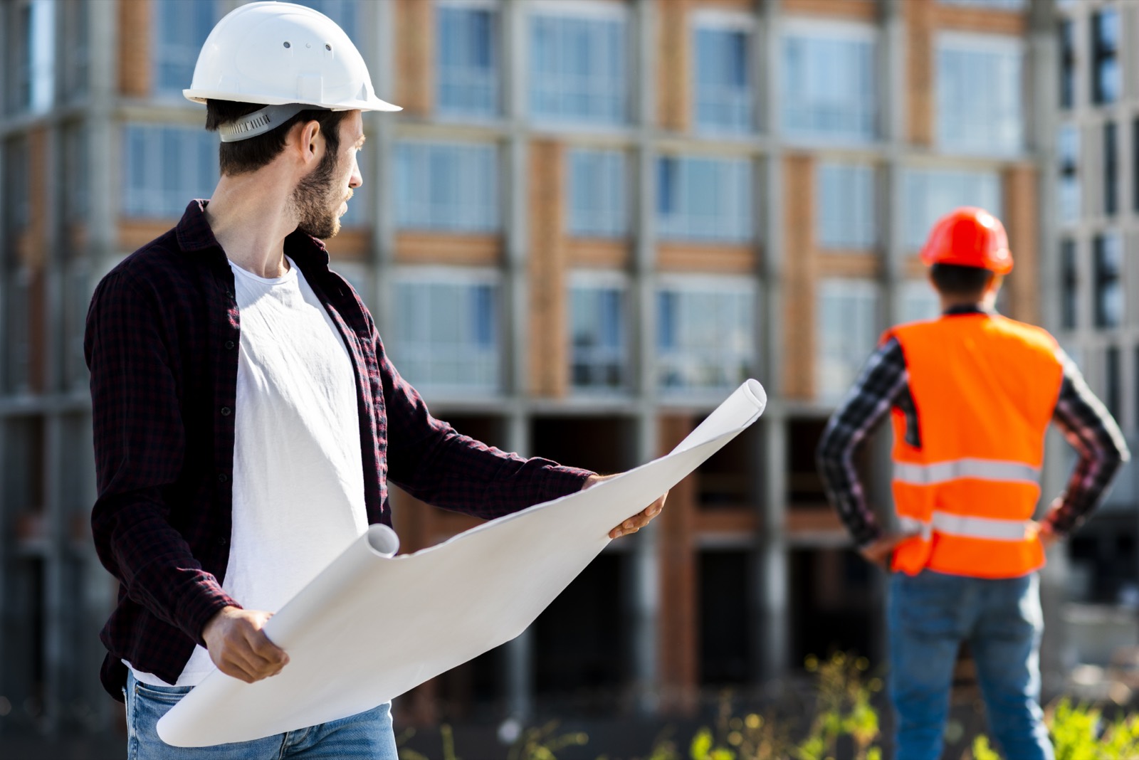 Architect supervising construction and reviewing documents