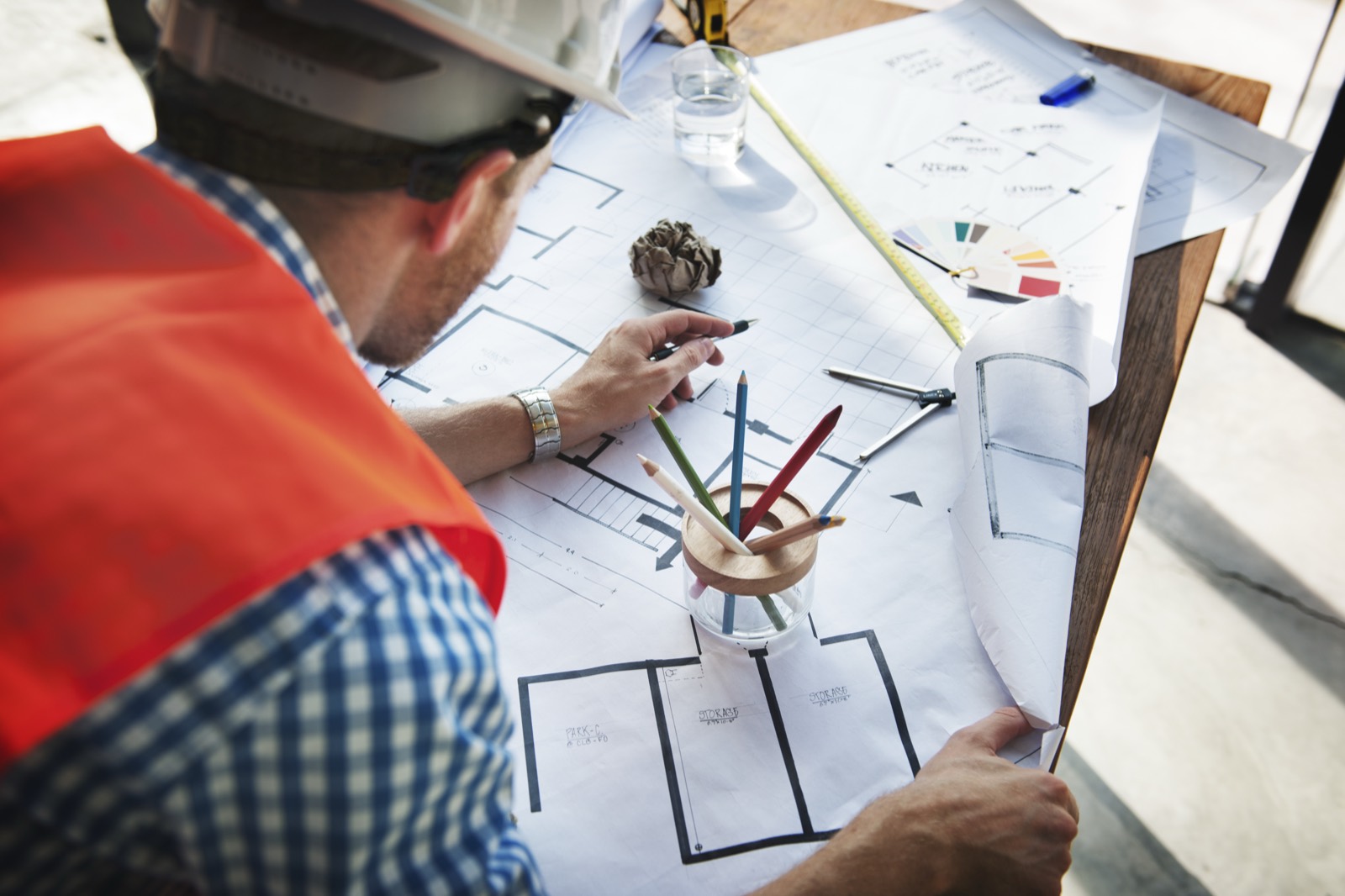 Engineer working on architectural blueprints