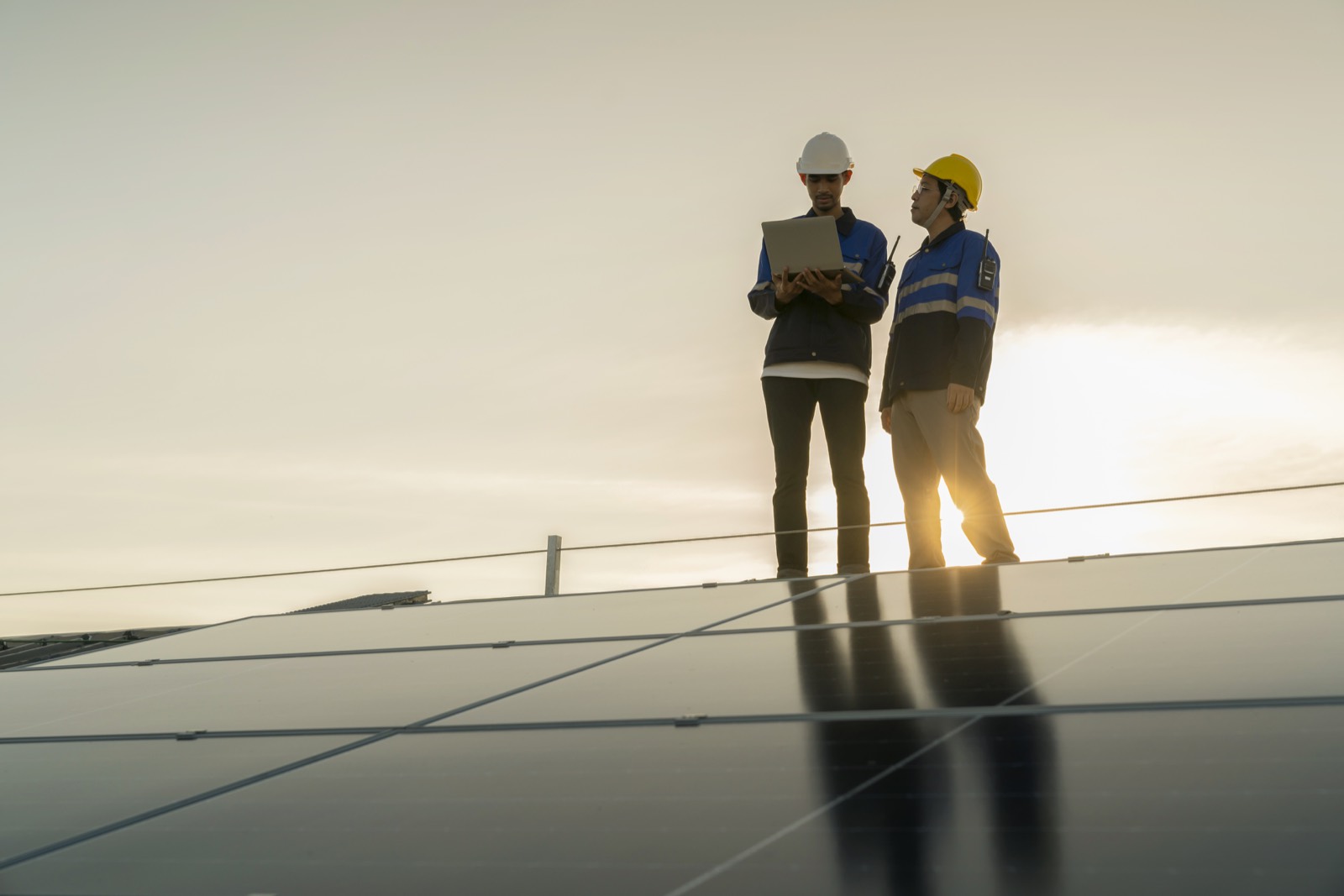 Technician performing long-term maintenance on solar panels