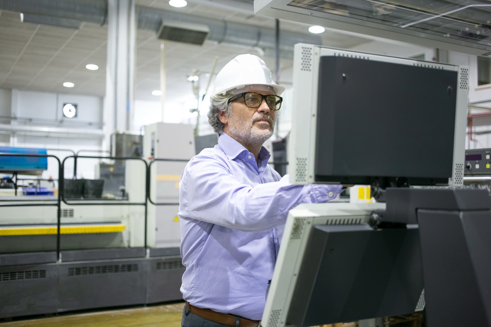 Plant manager operating an industrial control panel